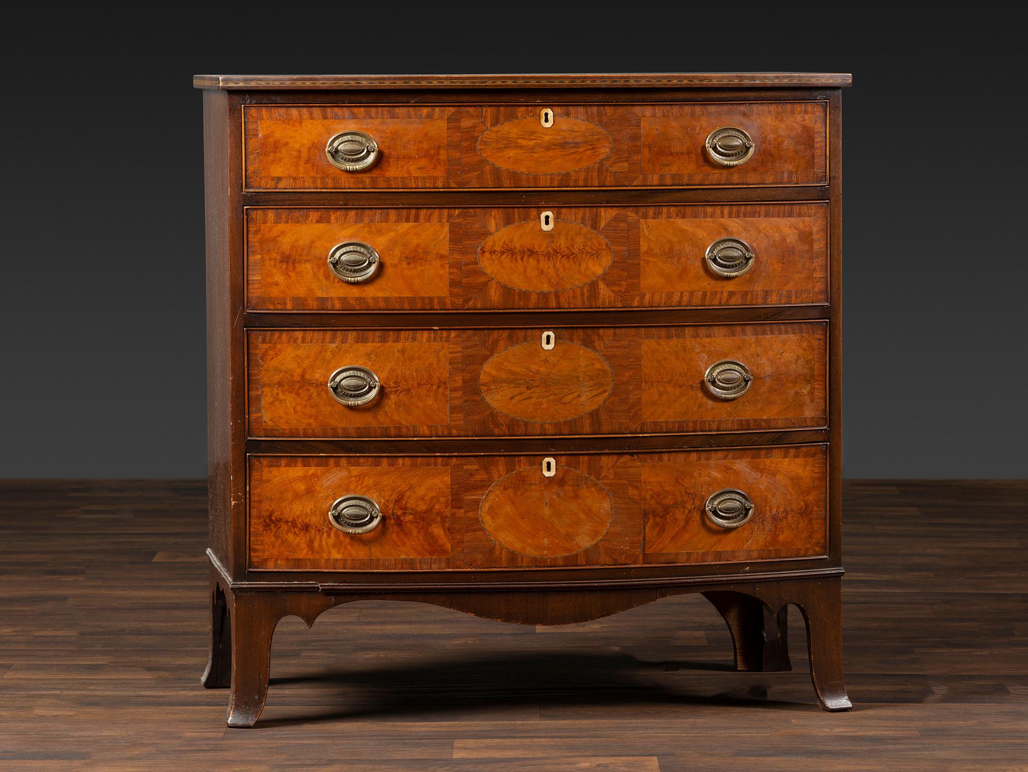 A Federal Inlaid and Figured Mahogany Bow-Front Chest of Drawers