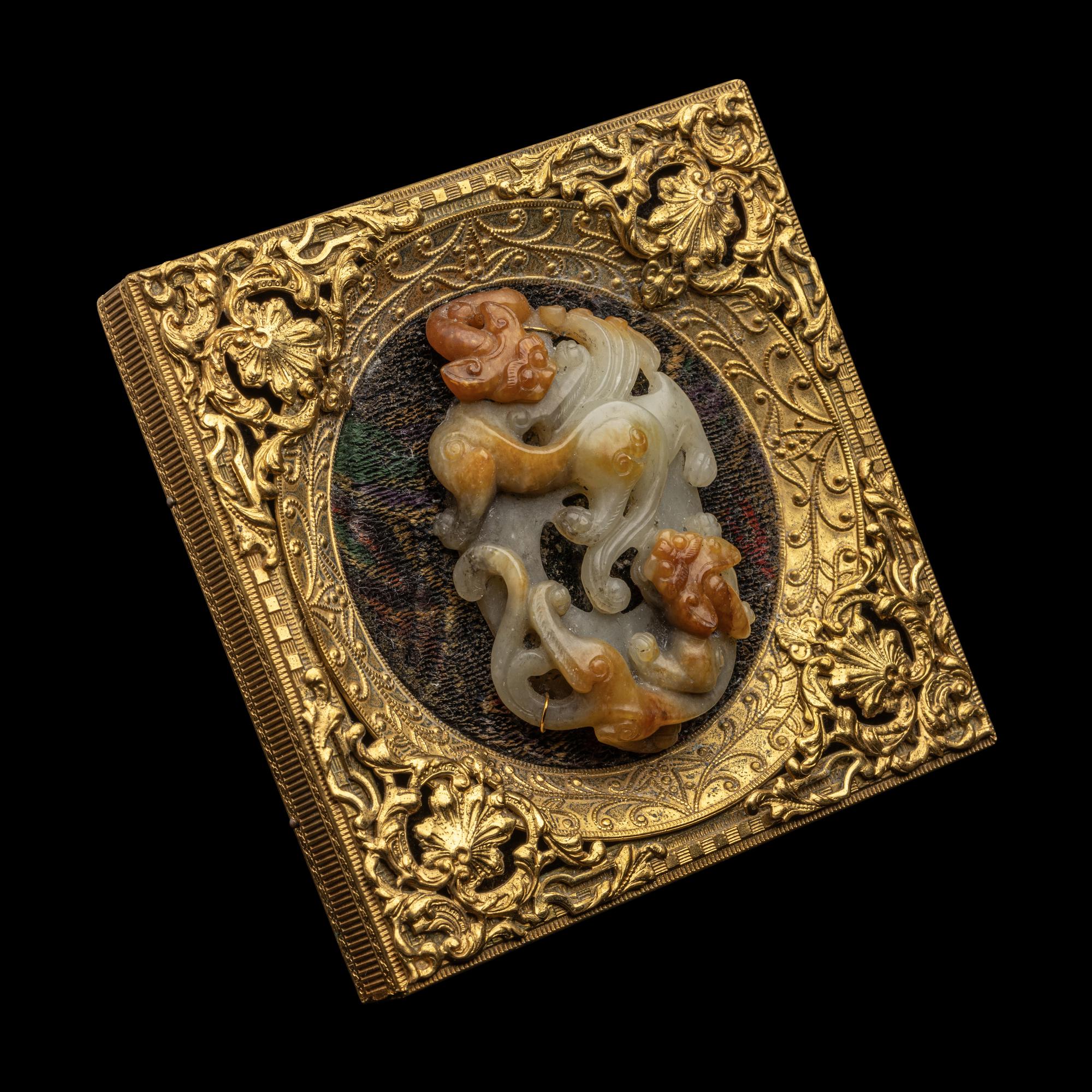A Chinese Russet and Pale Celadon Jade 'Double Dragons' Pendant