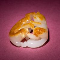 A Chinese Russet and Jade 'Double Badger' Pendant, 18th/19th Century — 清中期 白玉帶皮如意雙歡佩