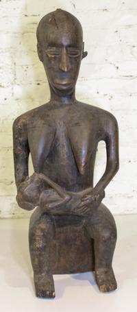 An African Carved Wood Maternity Figure. Height 31 1/2 inches.