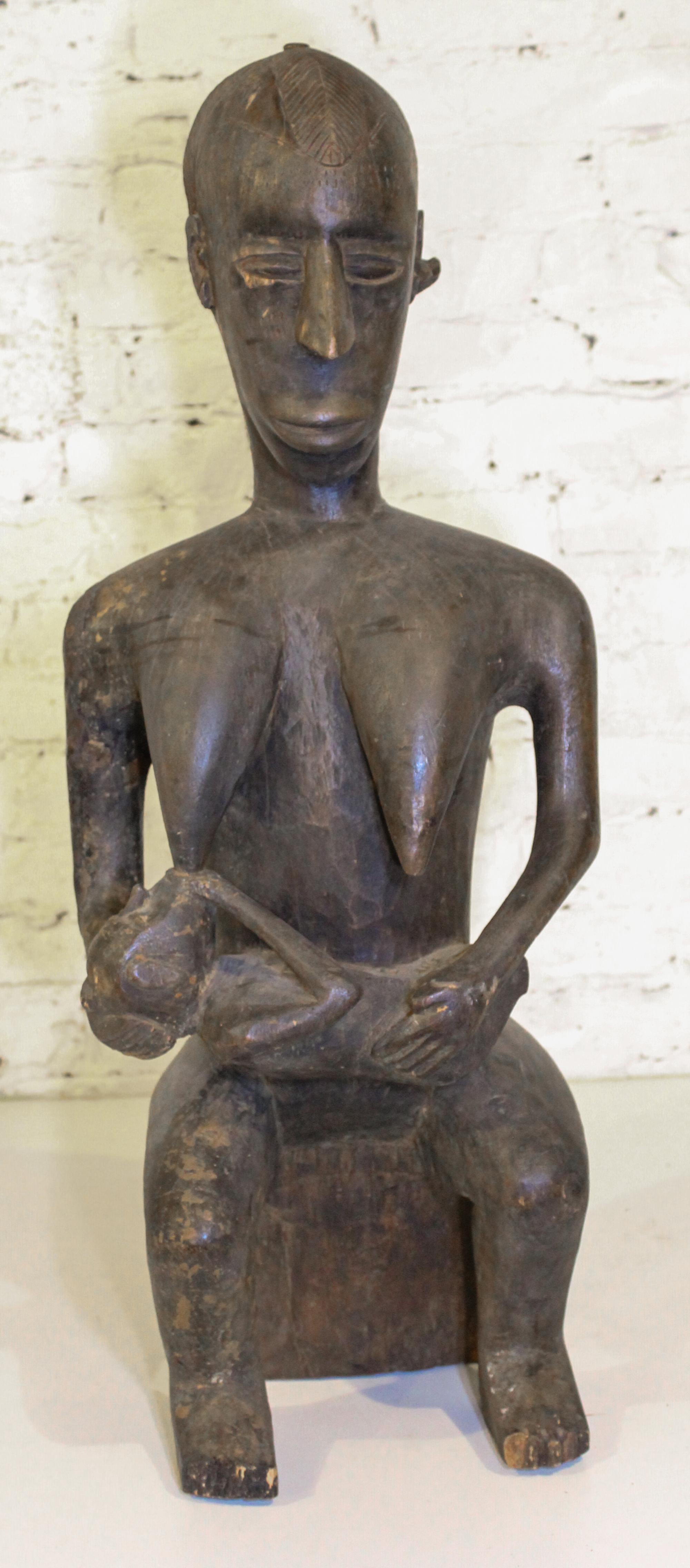 An African Carved Wood Maternity Figure. Height 31 1/2 inches.