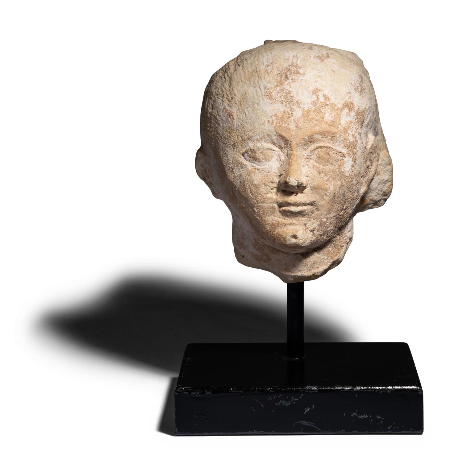 An Egyptian Limestone Head of a Boy