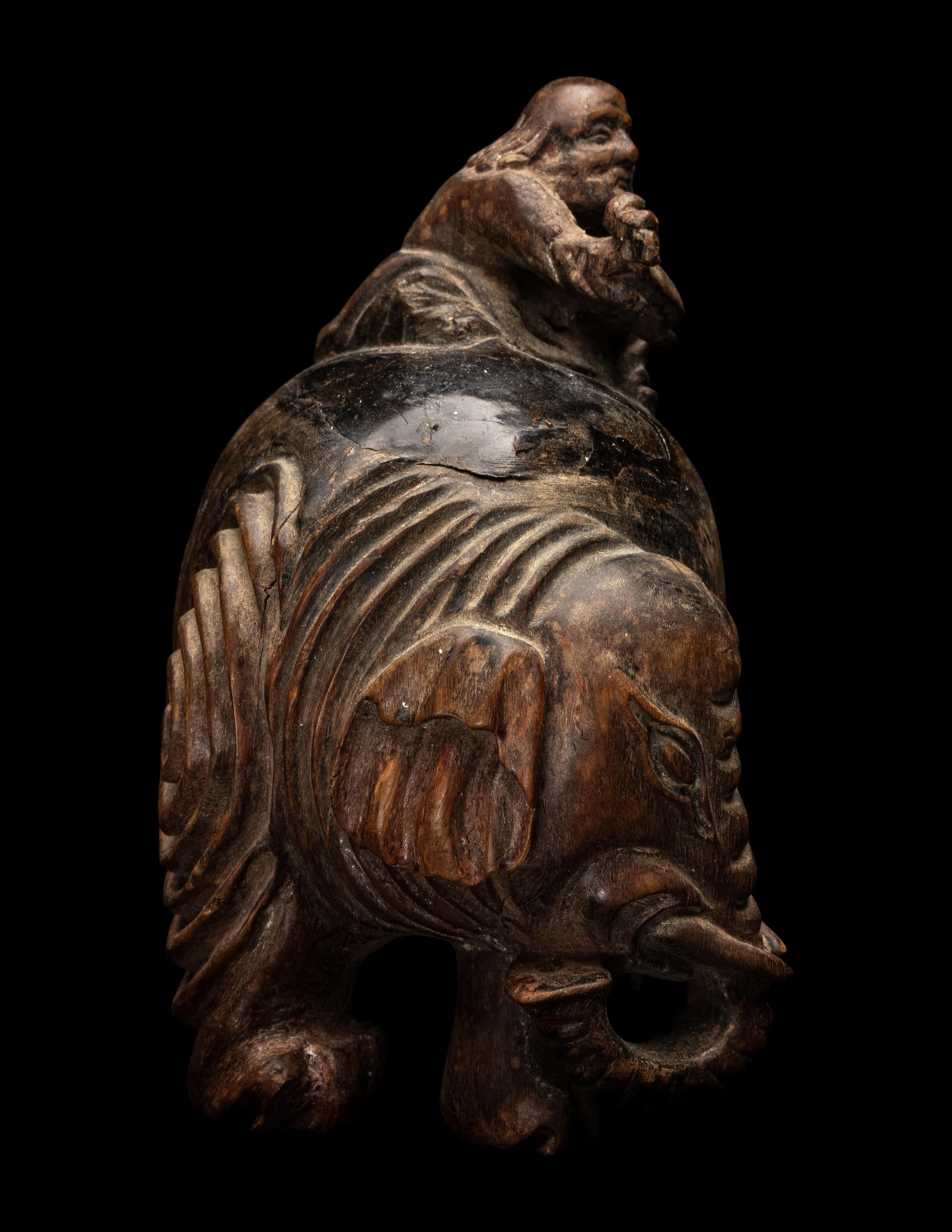 A Chinese Carved Wood 'Foreigner and Elephant' Figural Group