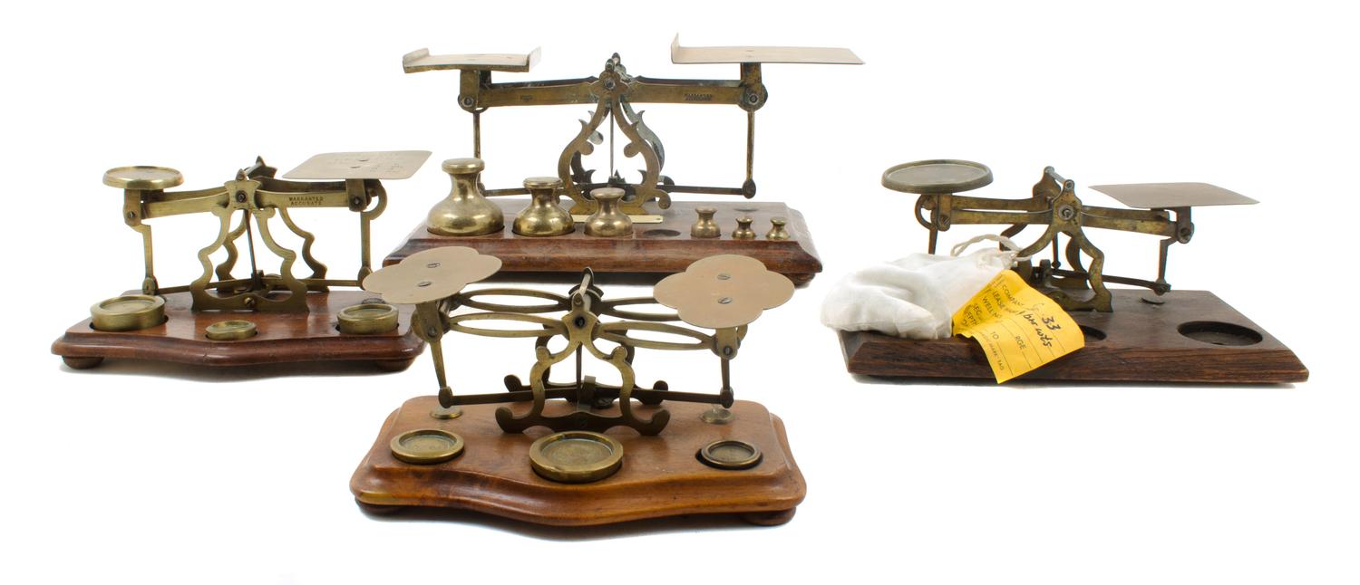 A Group of Four Brass Postal Scales and Weights Width of largest 11 inches.