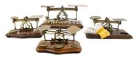 A Group of Four Brass Postal Scales and Weights Width of largest 11 inches.