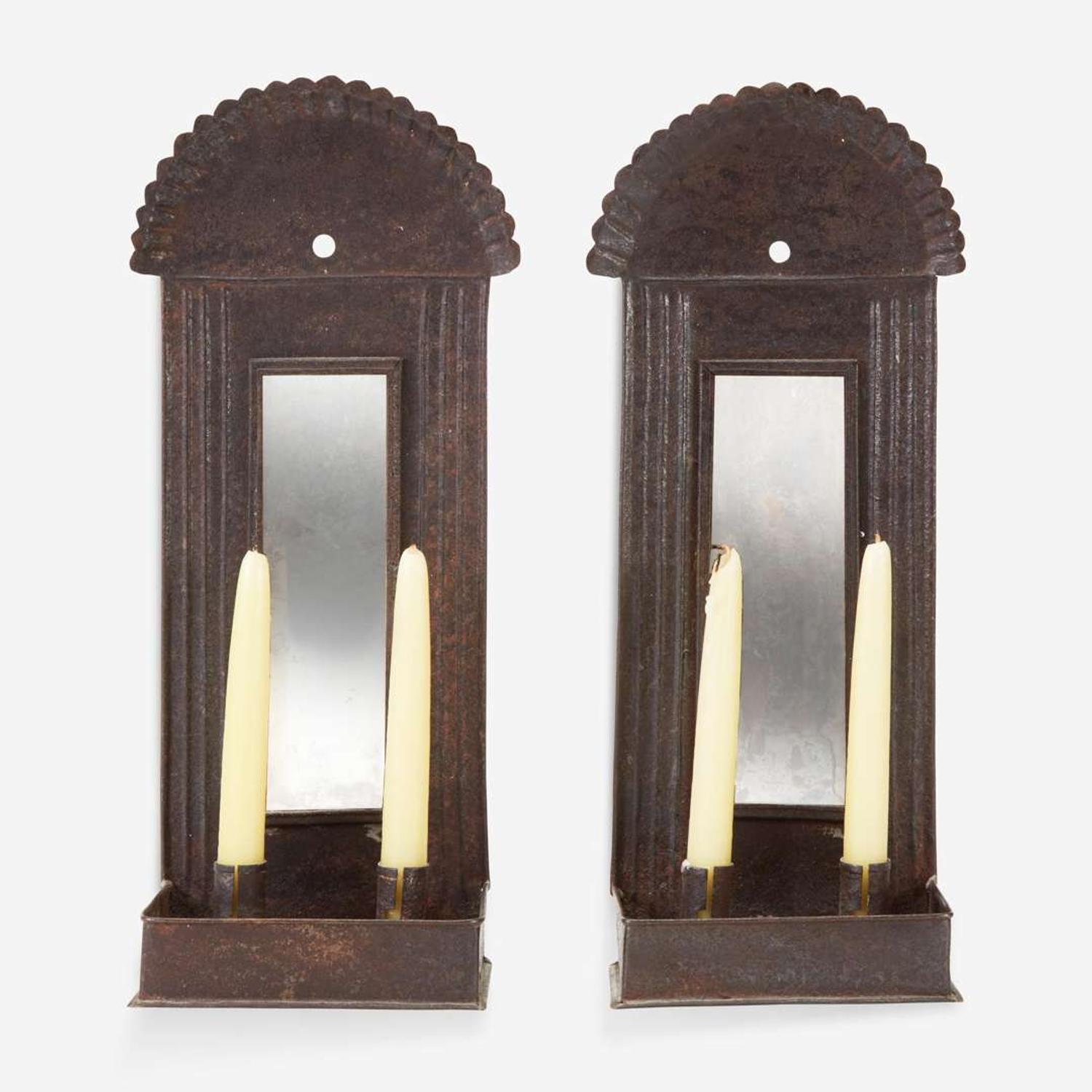 A pair of mirrored tinware candle sconces 20th century