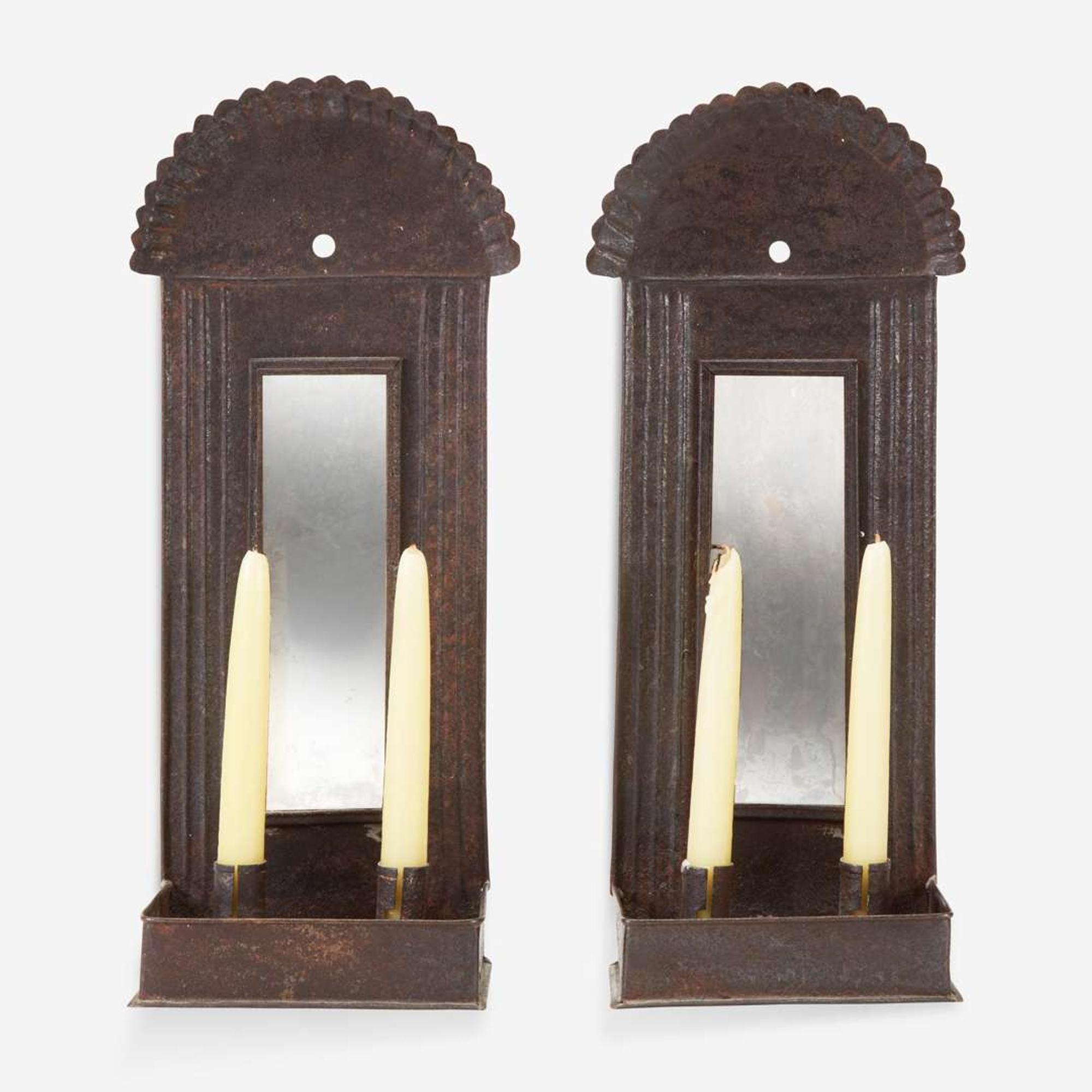 A pair of mirrored tinware candle sconces 20th century