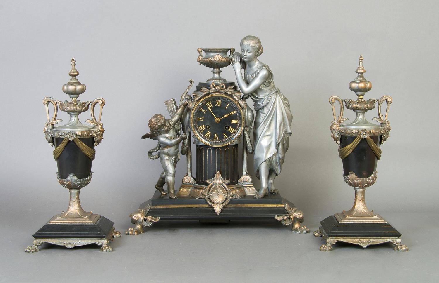 A Victorian Slate and Cast Metal Figural Clock Garniture, Height of clock 14 3/4 inches.