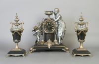 A Victorian Slate and Cast Metal Figural Clock Garniture, Height of clock 14 3/4 inches.