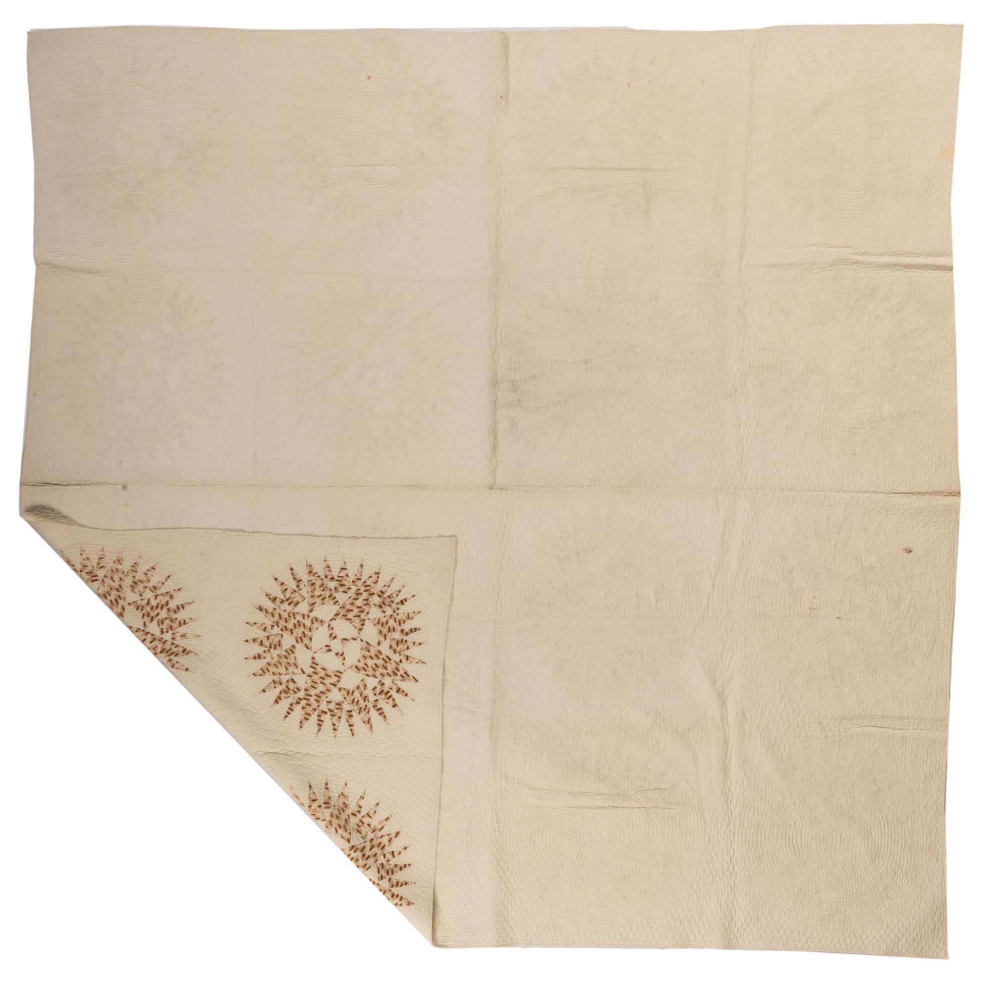 A Pieced Sunburst Quilt and a White Matelasse Coverlet