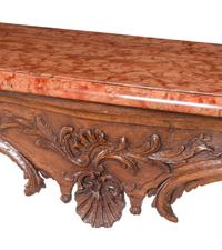 A Régence Carved Walnut Marble-Top Center Table
