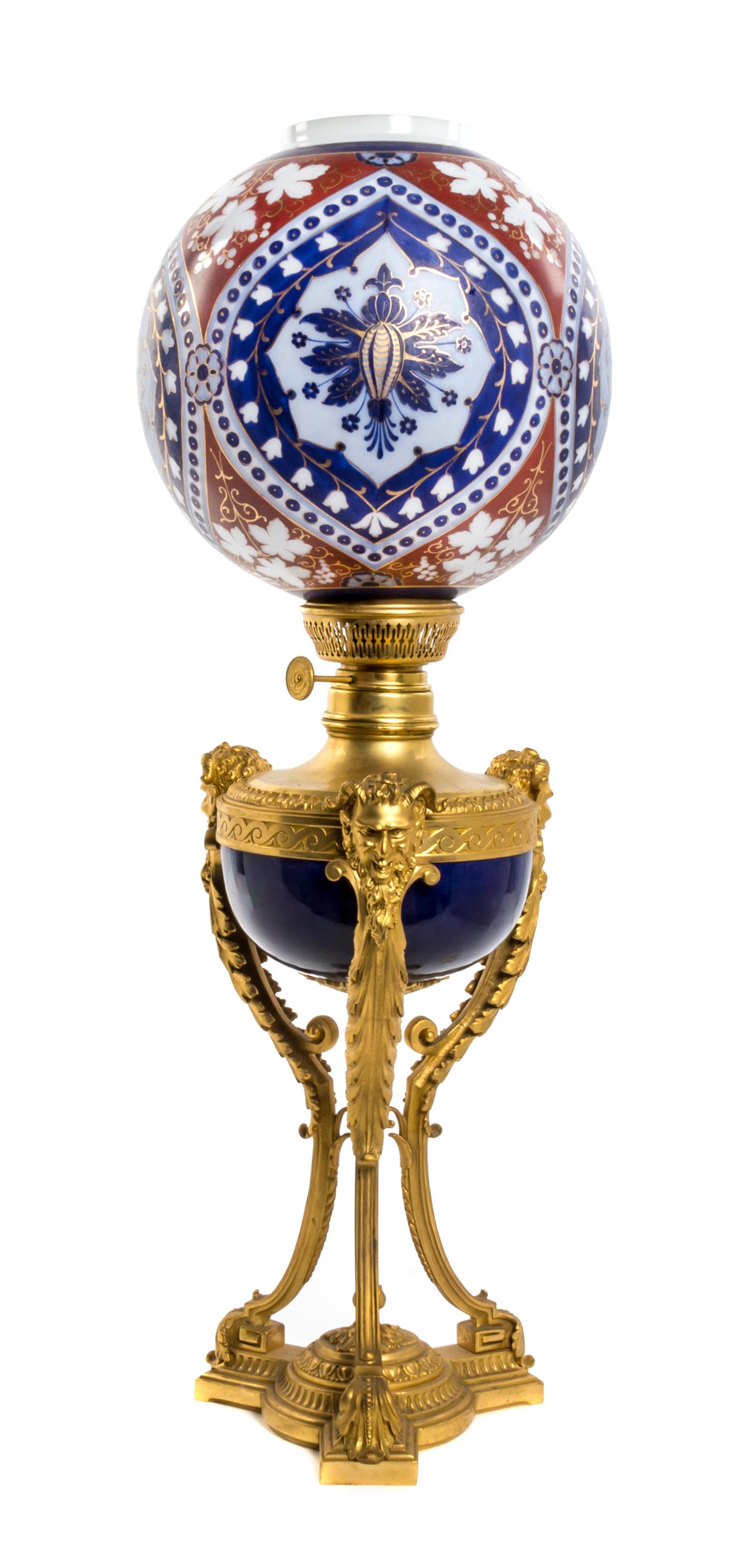 A French Gilt Bronze and Porcelain Oil Lamp, Height 29 3/4 inches.