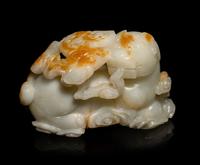 A Chinese Russet and White Jade Carving of a Mythical Beast
