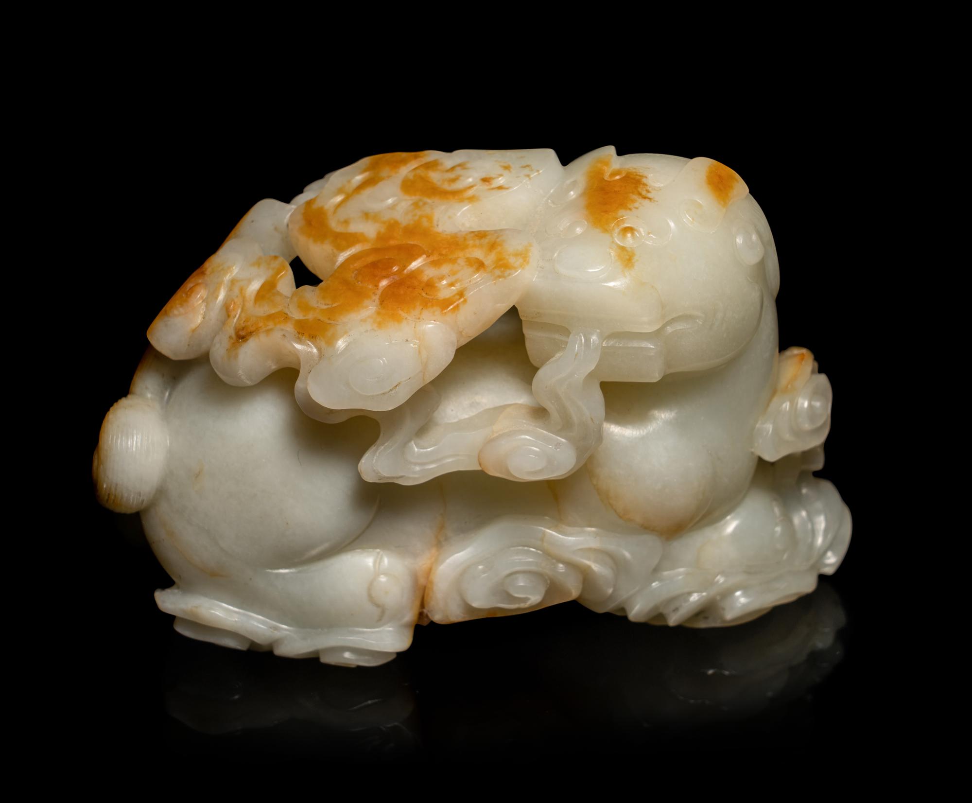 A Chinese Russet and White Jade Carving of a Mythical Beast