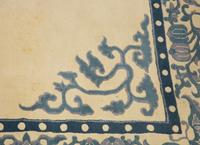 An Indian Blue and Ivory Chinese Style Wool Rug