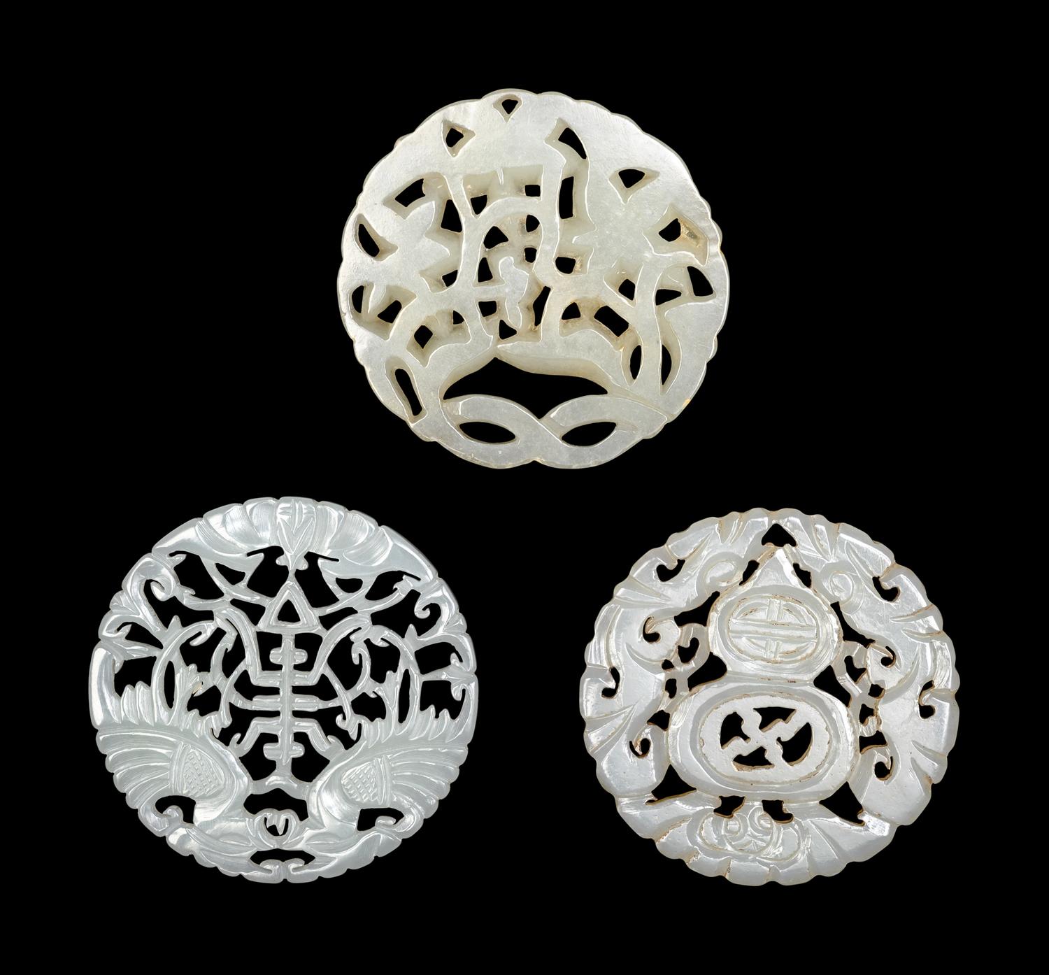 Three Chinese Pale Celadon Jade Circular Reticulated Plaques