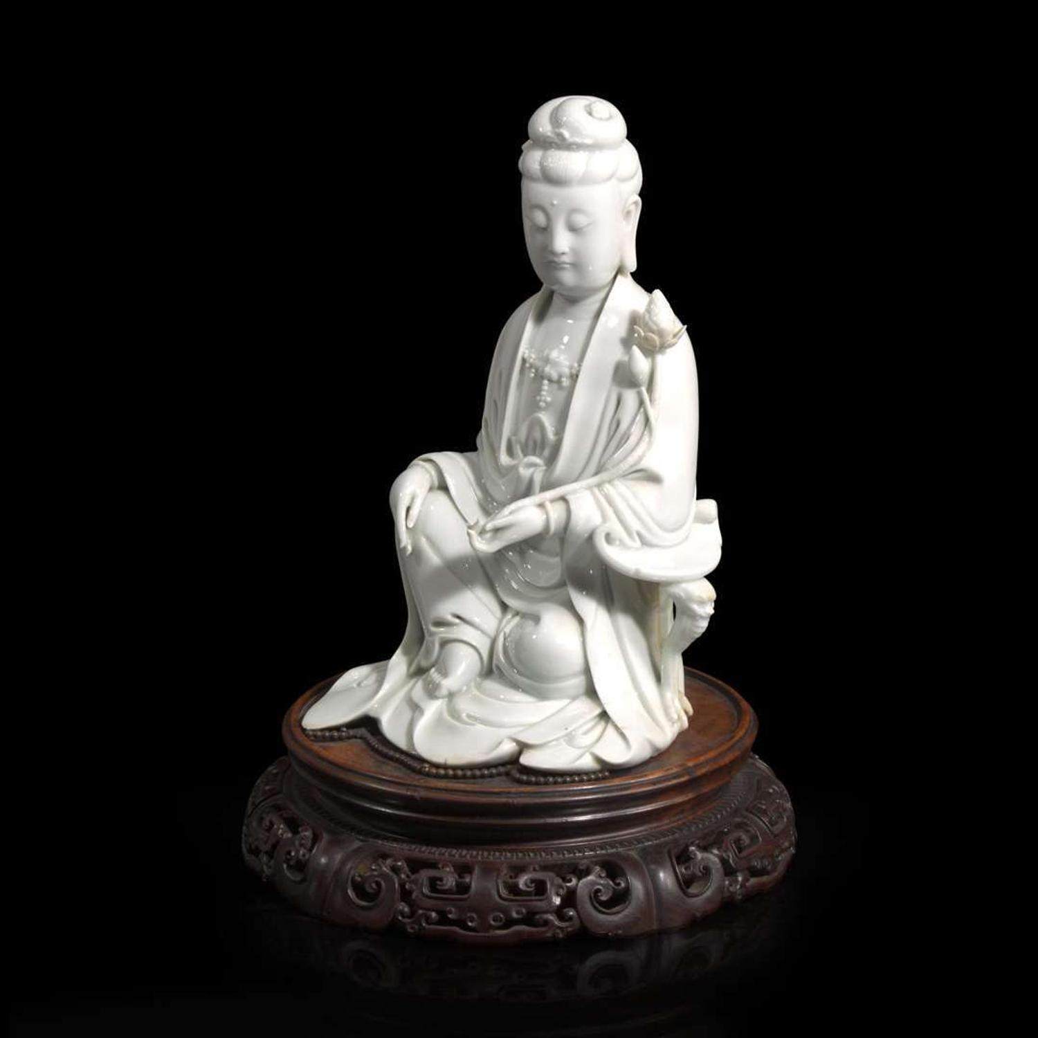 A Chinese blanc de Chine figure of Guanyin seated, with lotus 白瓷持莲观音像 Boji Yuren seal mark ?????