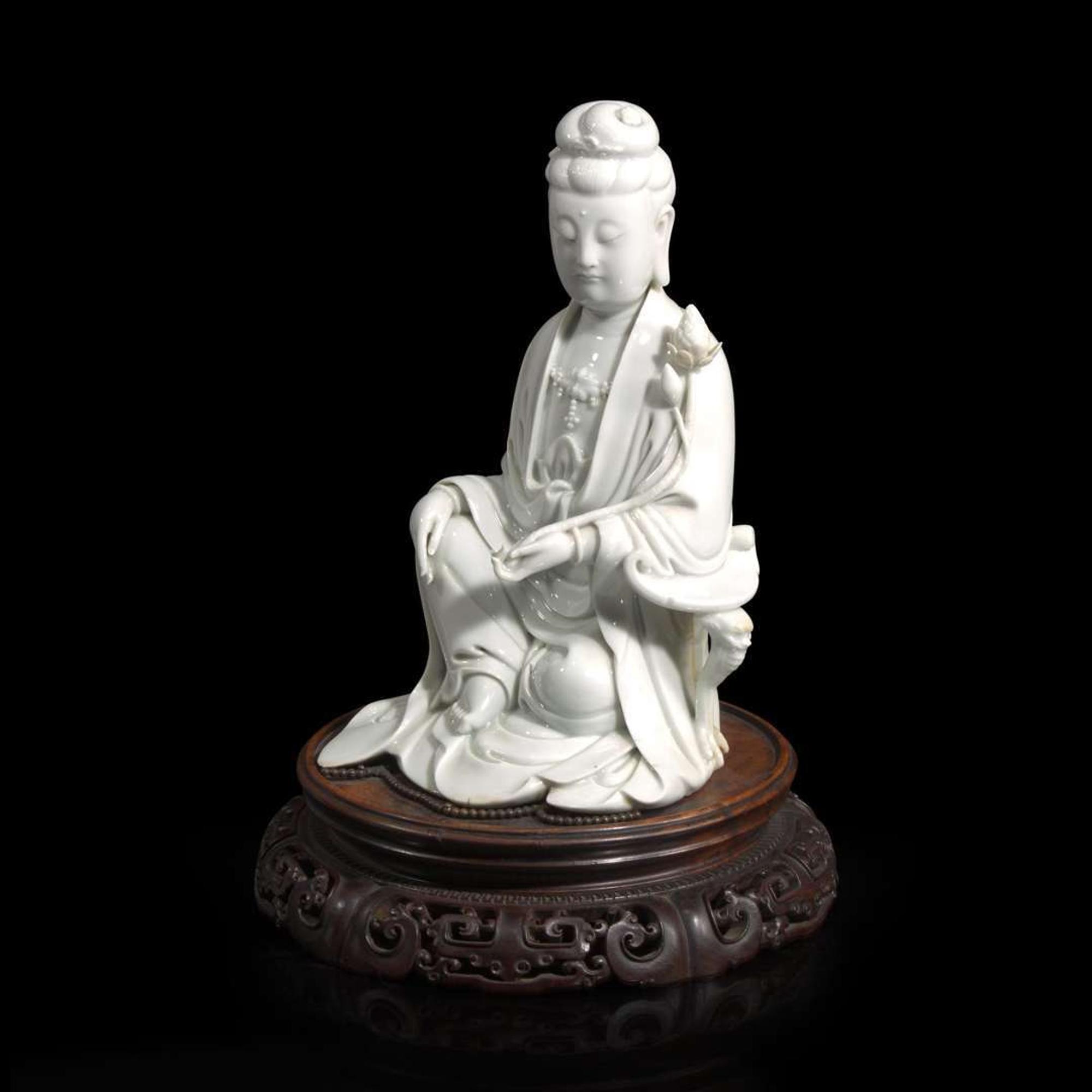 A Chinese blanc de Chine figure of Guanyin seated, with lotus 白瓷持莲观音像 Boji Yuren seal mark ?????