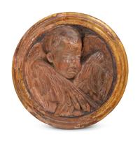 A Continental Parcel Gilt Terra Cotta Cherub Plaque