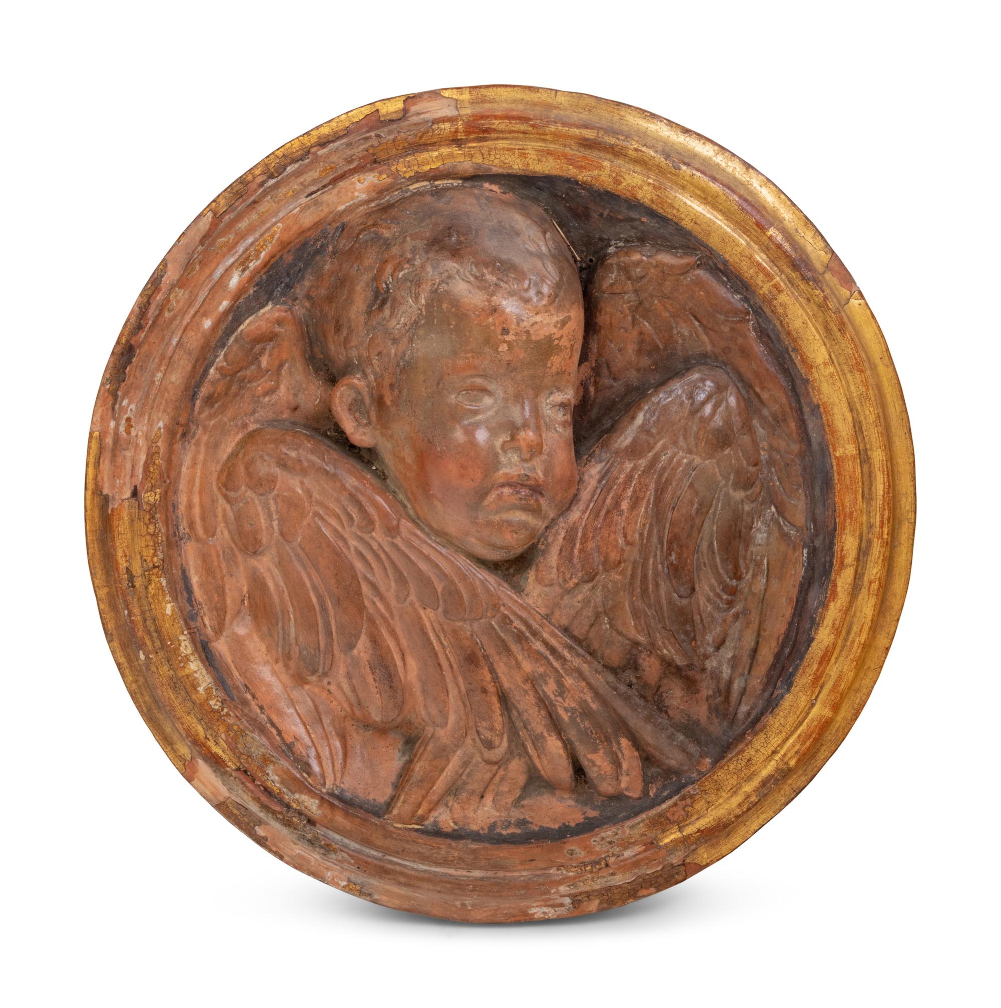 A Continental Parcel Gilt Terra Cotta Cherub Plaque