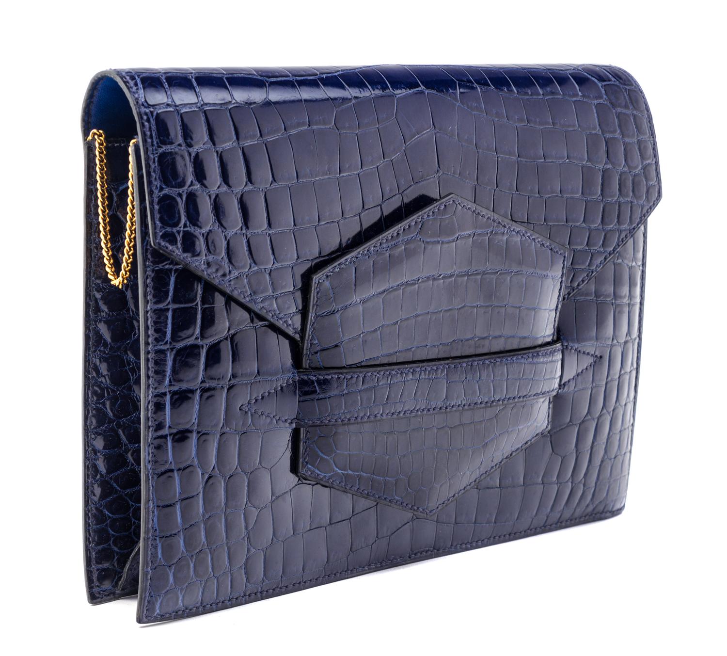 An Hermes Navy Niloticus Crocodile Faco Clutch, 9.25" x 7" x 1".