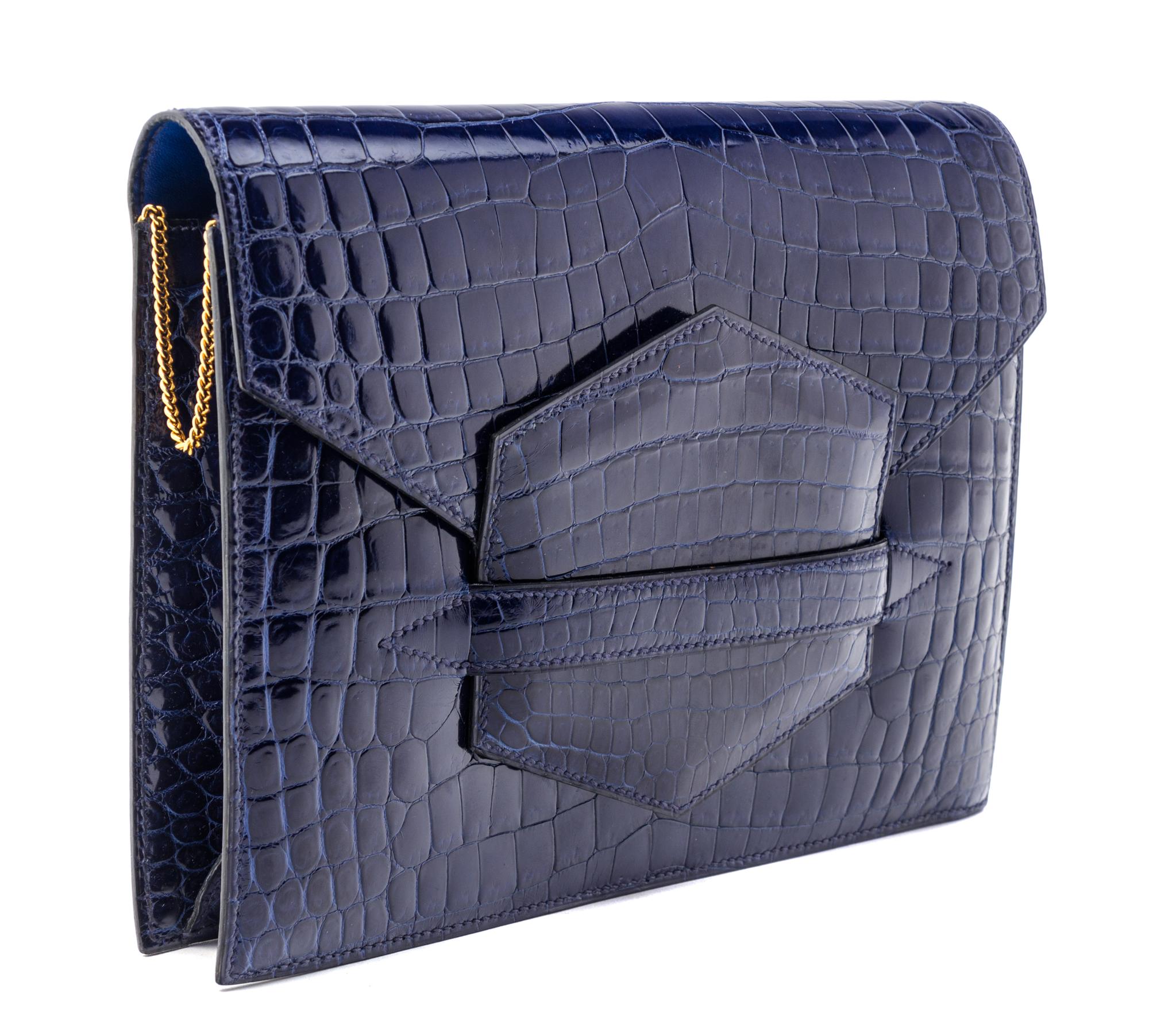 An Hermes Navy Niloticus Crocodile Faco Clutch, 9.25" x 7" x 1".