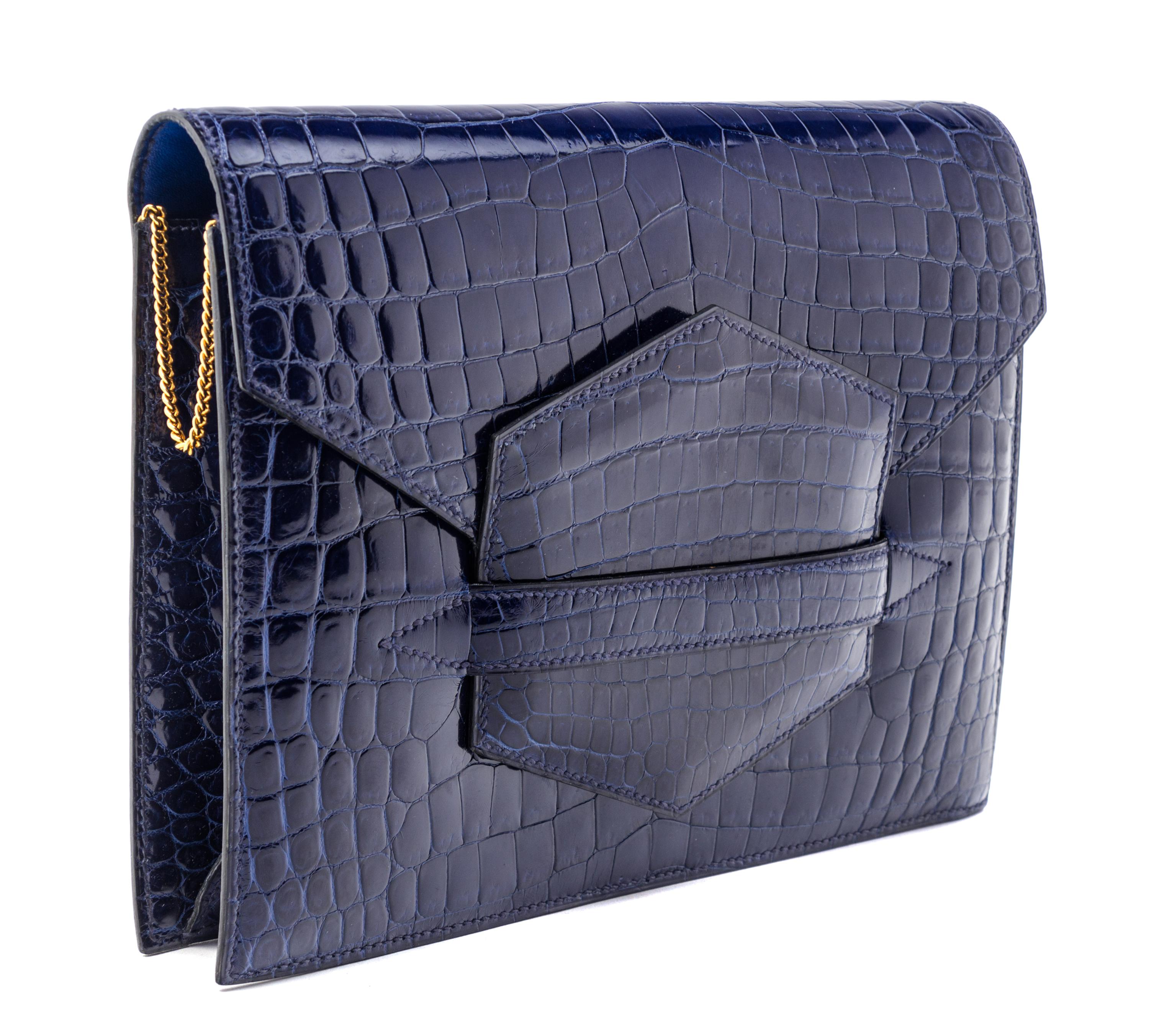 An Hermes Navy Niloticus Crocodile Faco Clutch, 9.25" x 7" x 1".