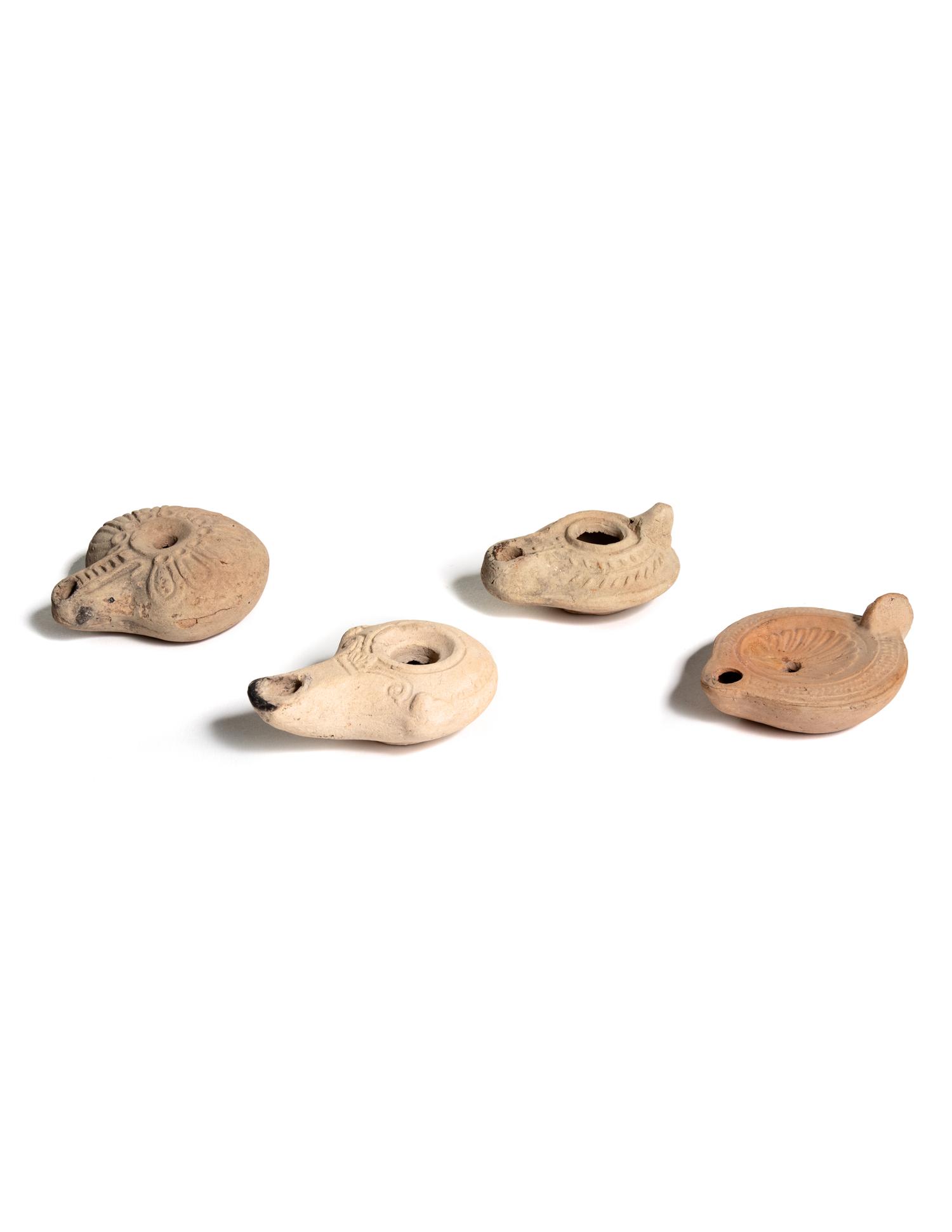 Four Roman Molded Terra Cotta Oil Lamps