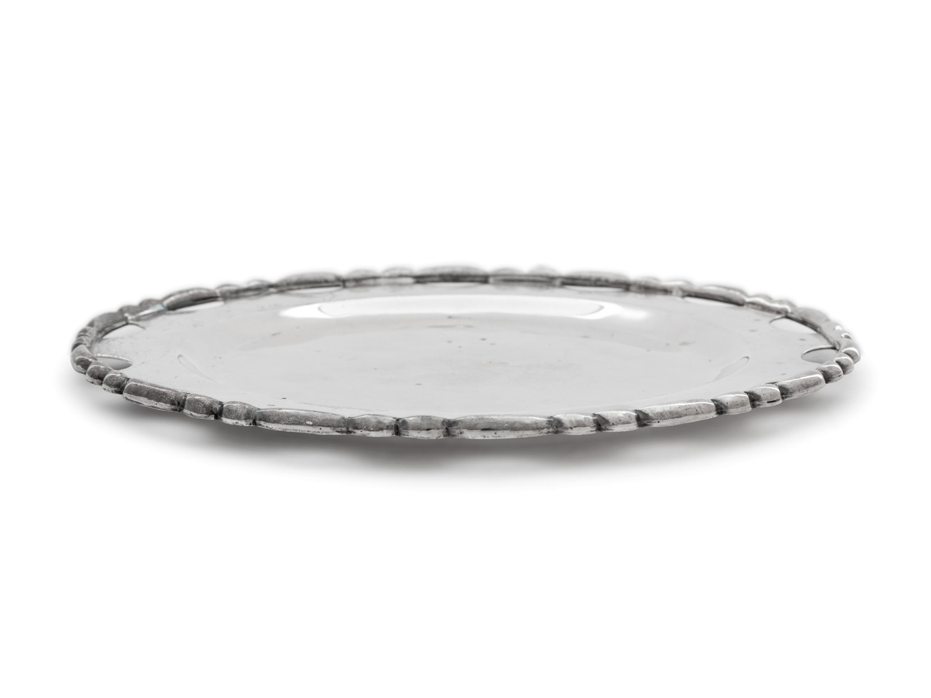 A Set of Twelve Mexican Silver Bread Plates
