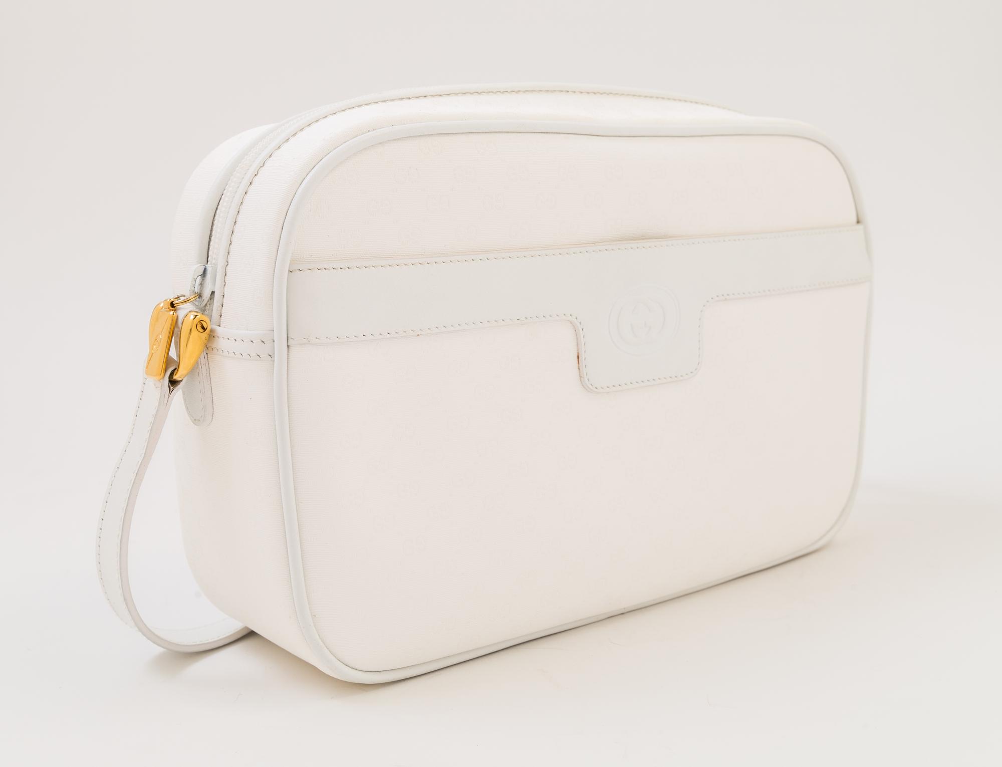 A Gucci White Monogram Canvas Handbag, 10" x 6.5" x 3"; Strap drop: 19".