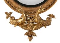 A Pair of Regency Carved Giltwood Convex Wall Mirrors
