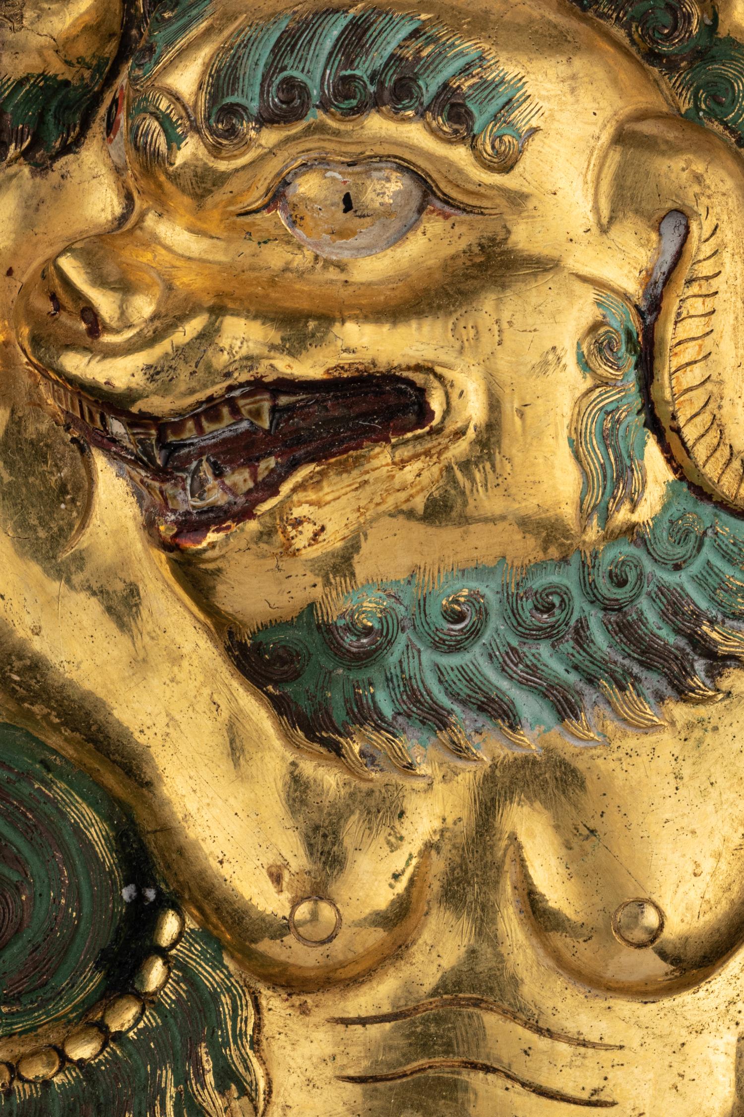 A Sino-Tibetan Gilt Bronze Repoussé Fu-Lion