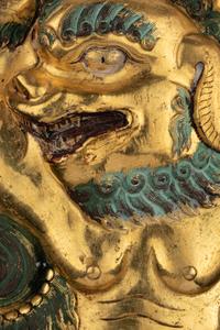 A Sino-Tibetan Gilt Bronze Repoussé Fu-Lion
