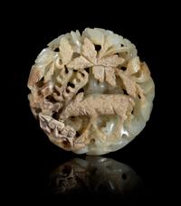A Carved Celadon and Russet Jade Pendant Diameter 2 1/8 inches.