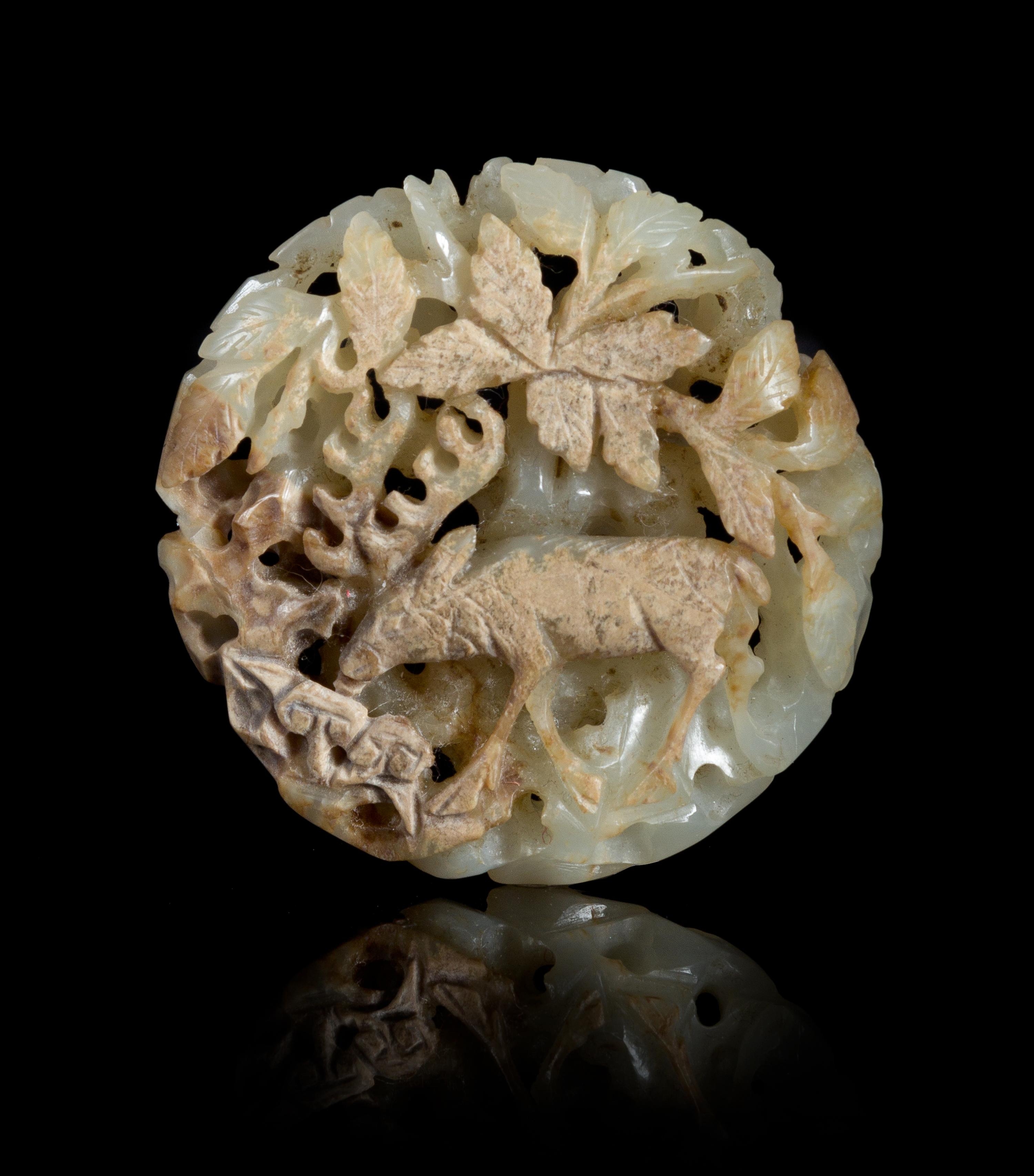 A Carved Celadon and Russet Jade Pendant Diameter 2 1/8 inches.