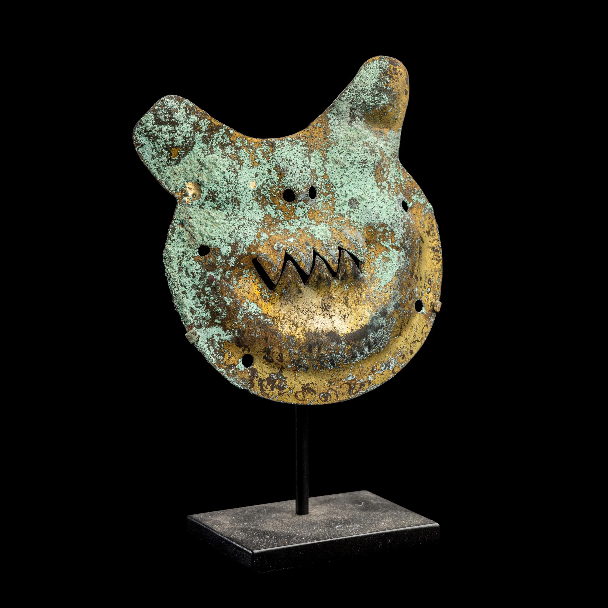 A Vicus Copper Gilt Feline Head Pendant