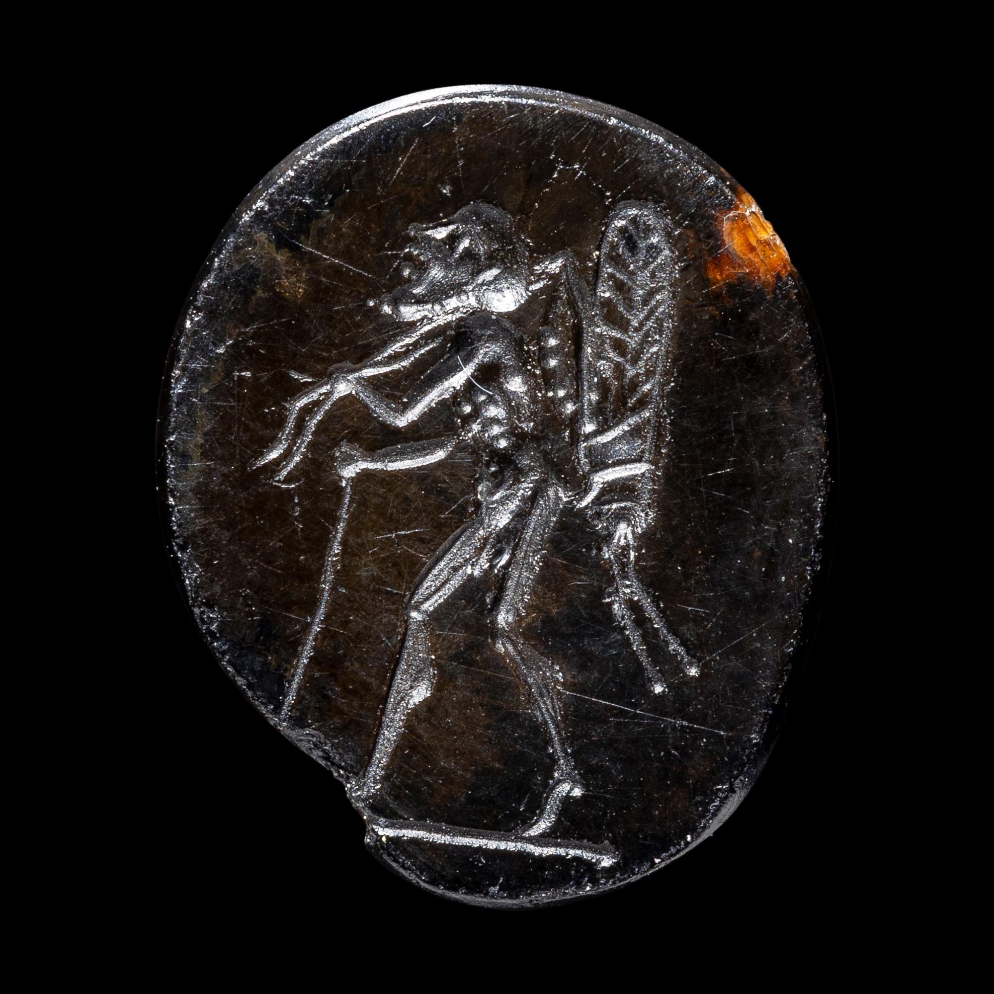 A Roman Sardonyx Ring Stone with a Pygmy and Locust