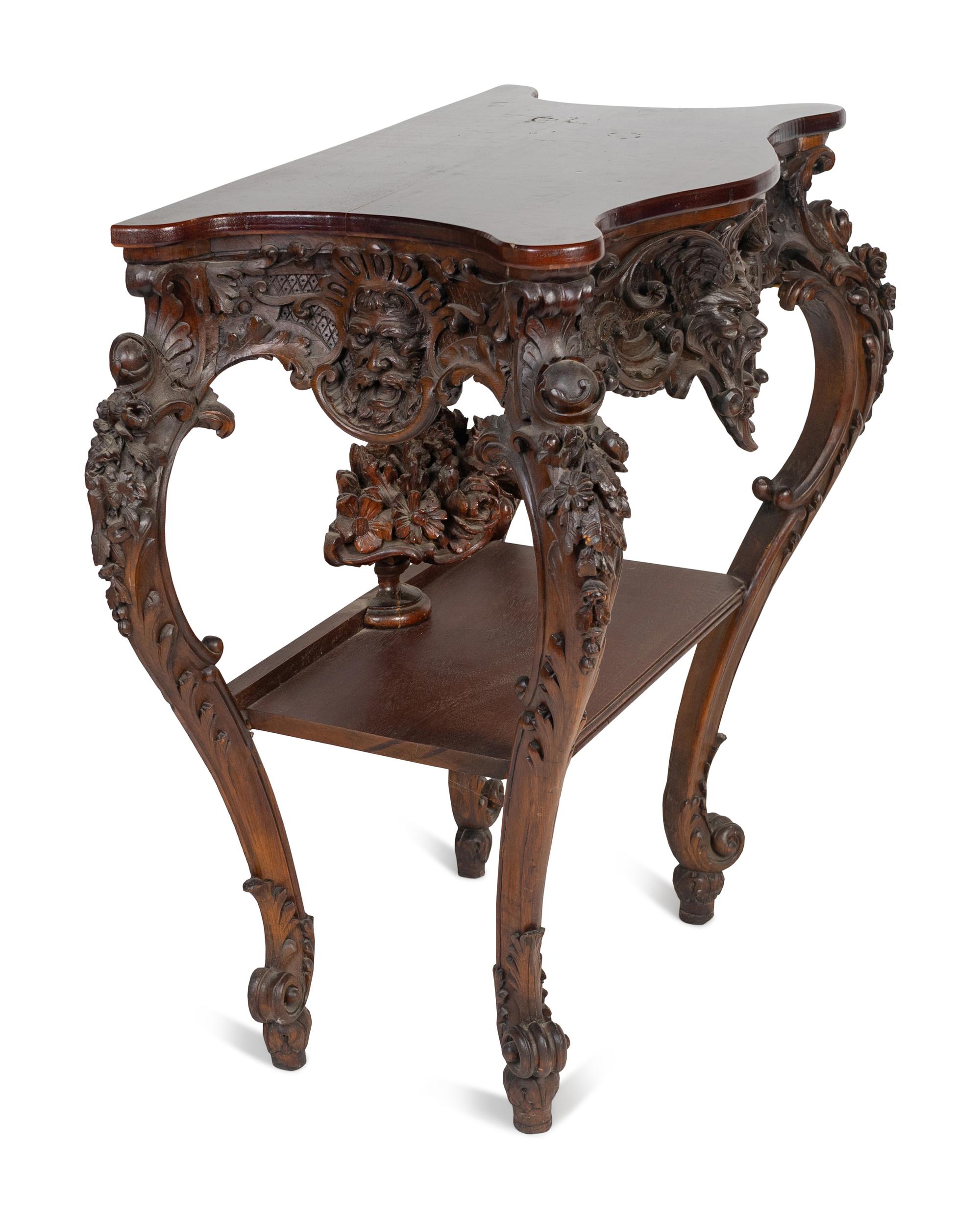 A Renaissance Revival Carved Walnut Serpentine Top Console Table