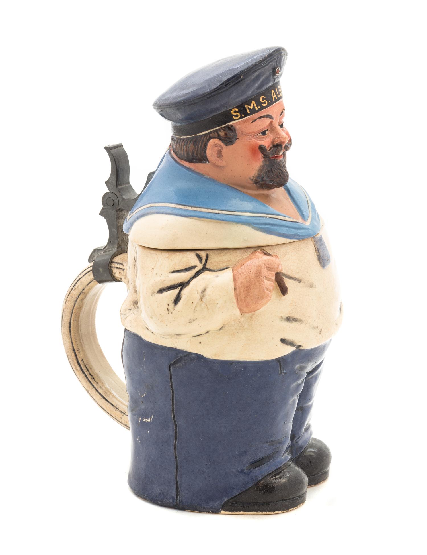 A German Pewter Mounted Ceramic Character Stein Height 8 1/2 inches.