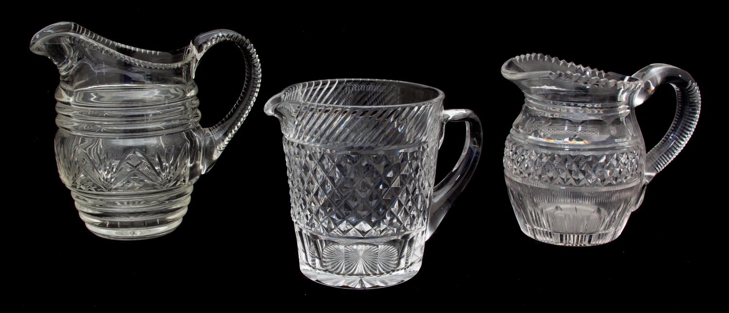 A Group of Three Cut Glass Pitchers Height of tallest 7 1/2 inches.