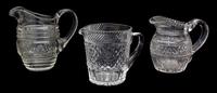 A Group of Three Cut Glass Pitchers Height of tallest 7 1/2 inches.