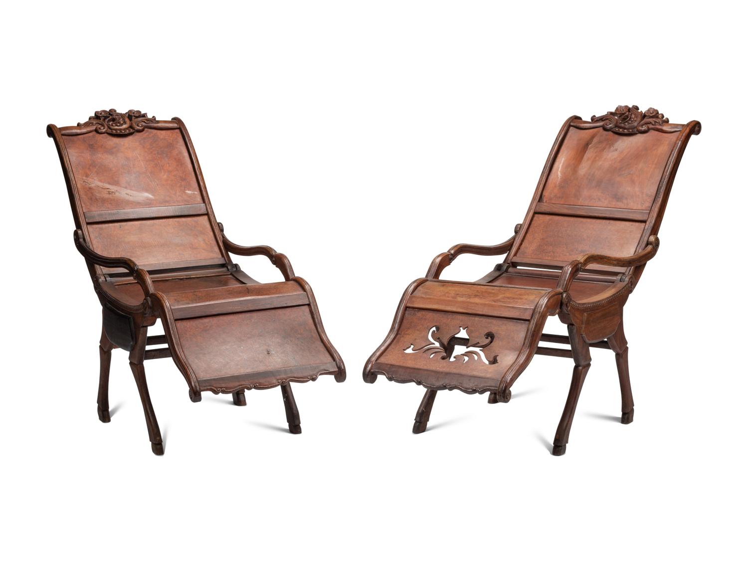 A Pair of Portuguese Colonial Carved Walnut Reclining Armchairs