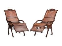 A Pair of Portuguese Colonial Carved Walnut Reclining Armchairs