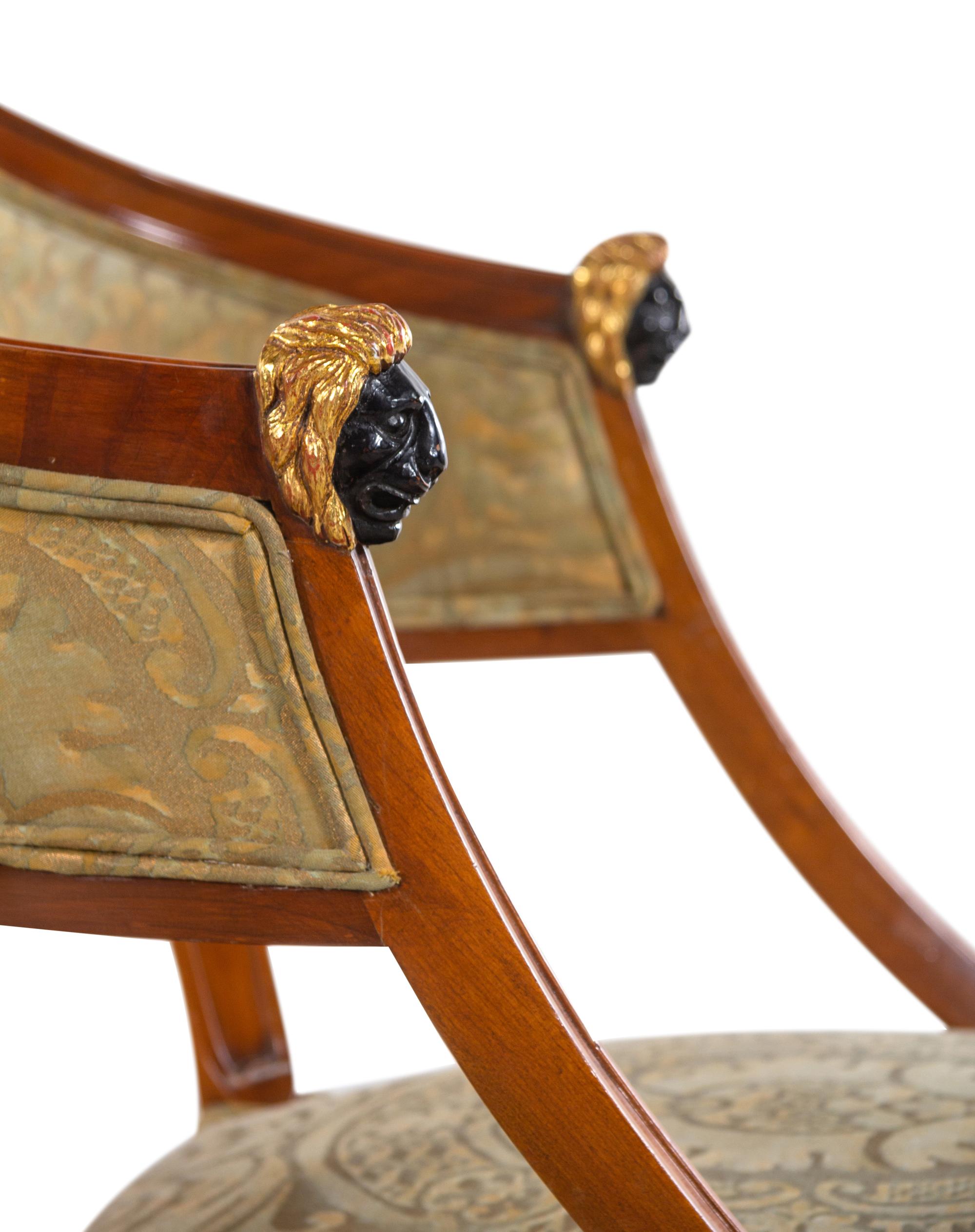 A Pair of Empire Style Parcel Gilt and Ebonized Bergères