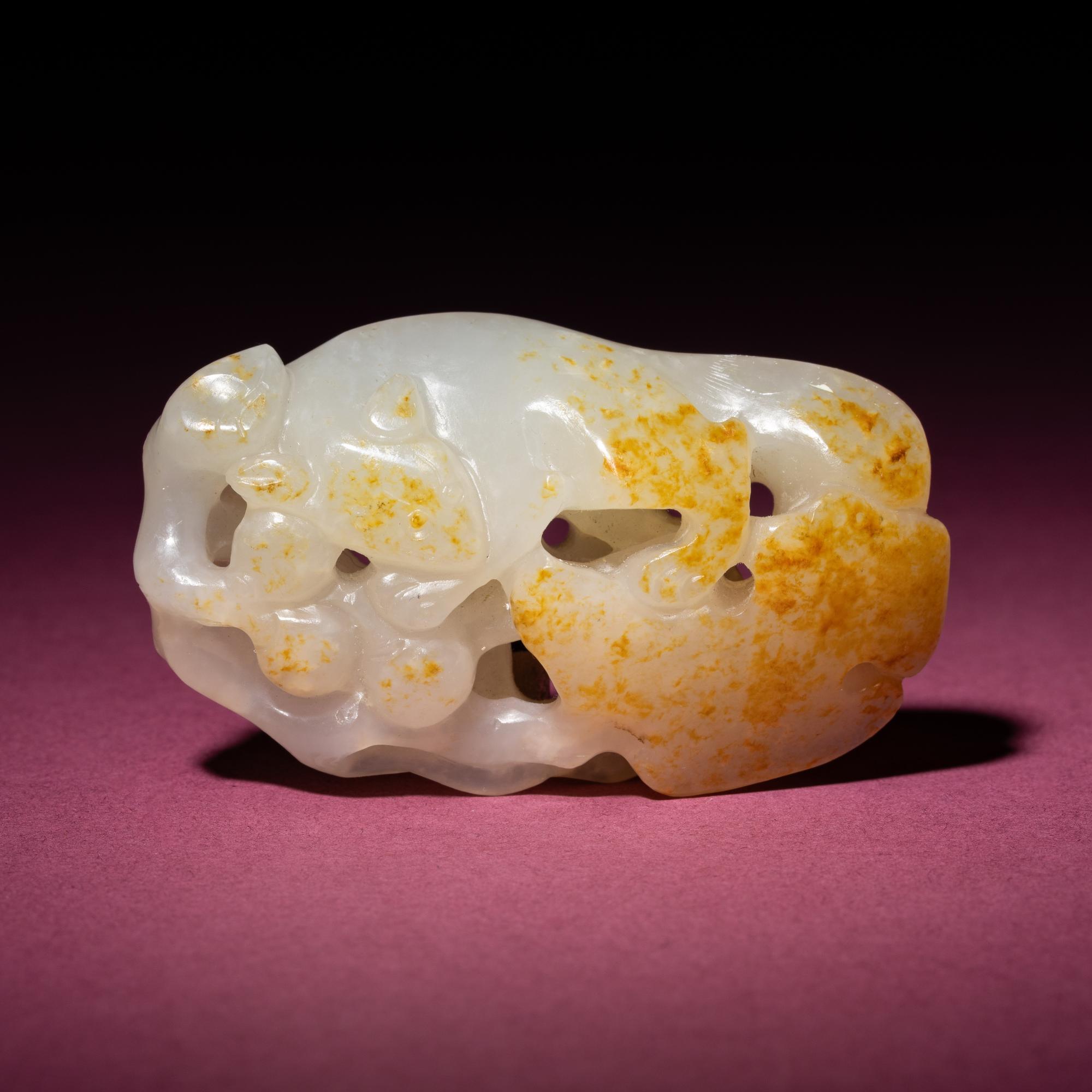 A Chinese Russet and White Jade 'Squirrel and Grape' Carving, 18th/19th Century — 清中期 白玉留皮松鼠葡萄