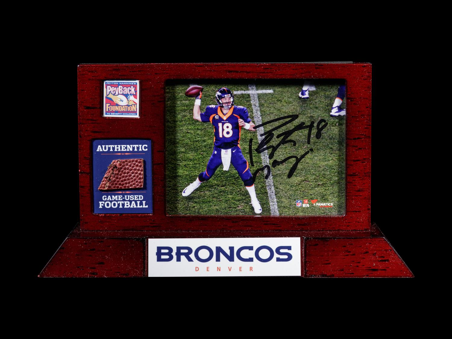A Peyton Manning Signed Photograph and Game Used Football Fragment (Fanatics Authentic),