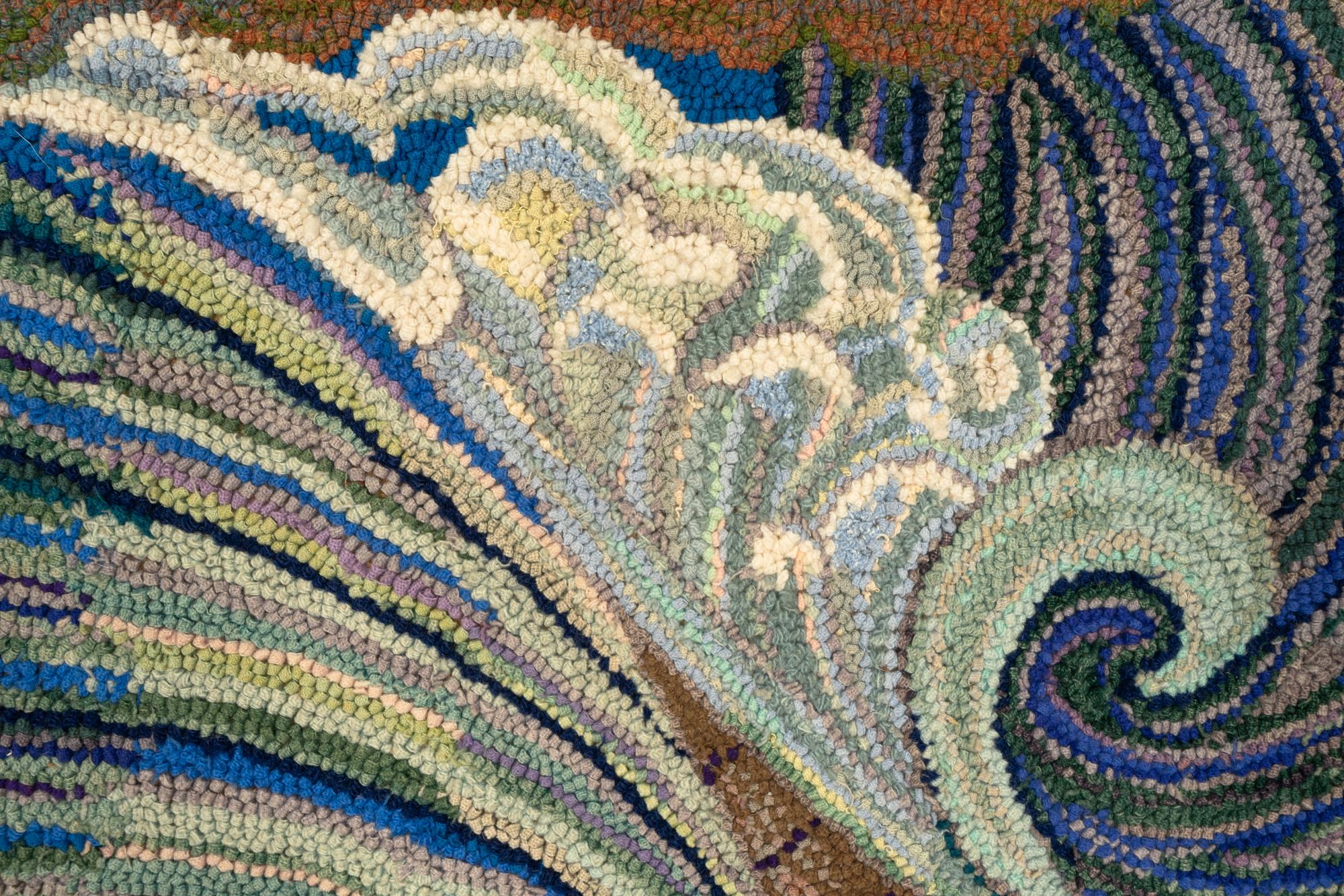 A Framed Hooked Rug Depicting Waves