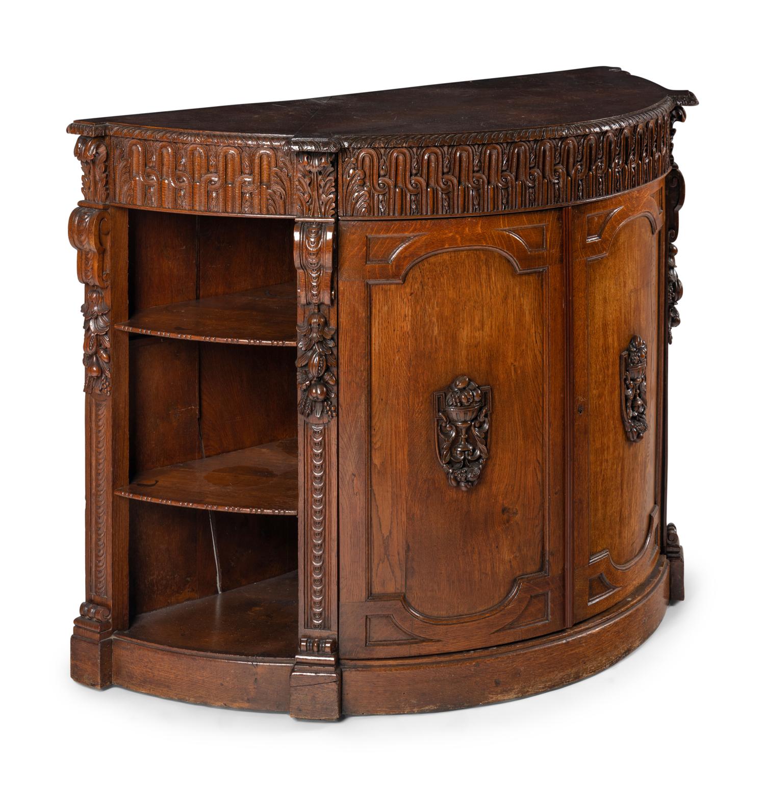 A Continental Carved Oak Demilune Cabinet