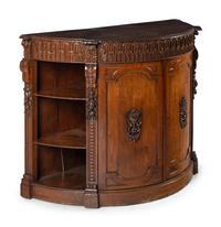 A Continental Carved Oak Demilune Cabinet