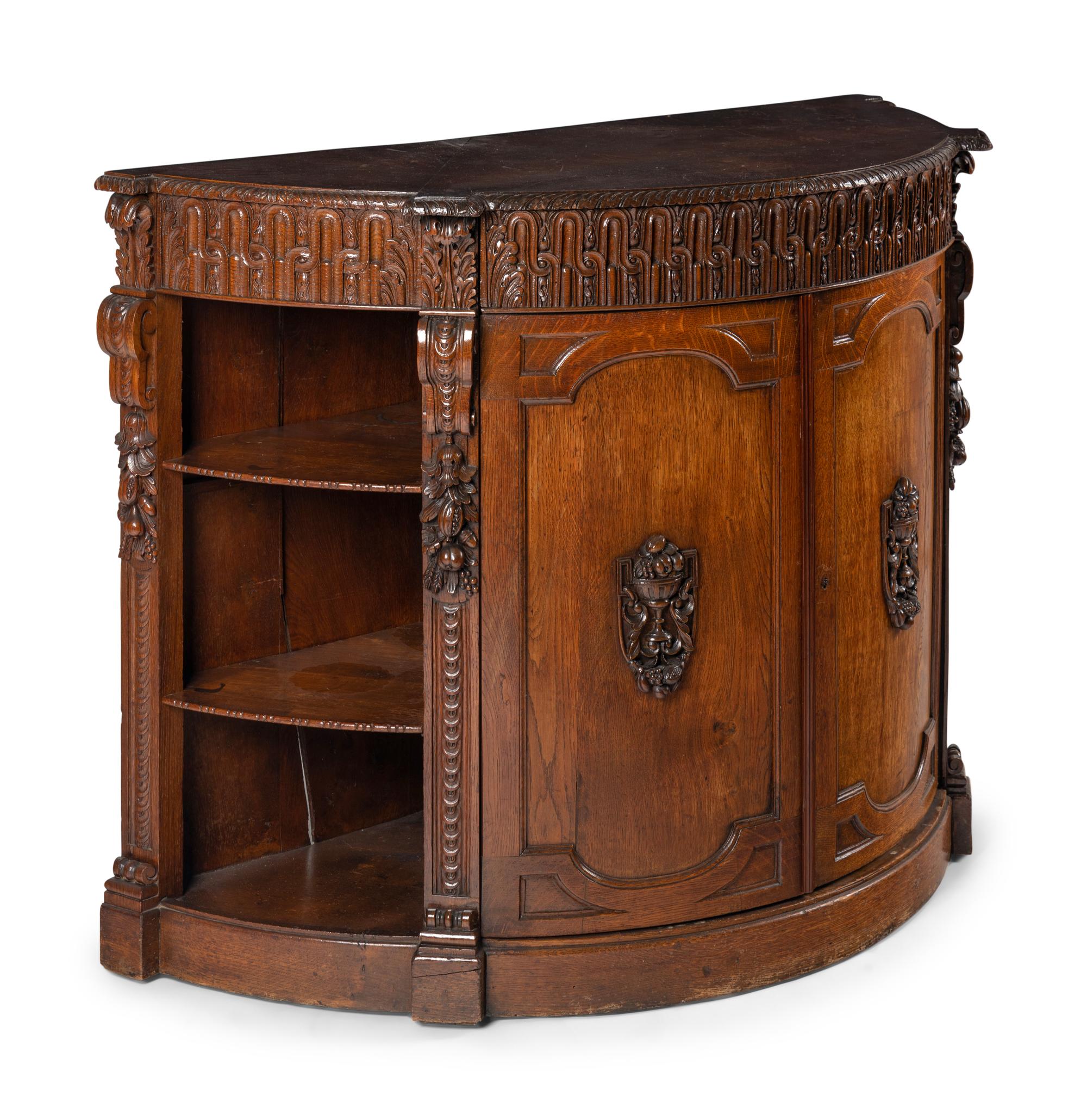 A Continental Carved Oak Demilune Cabinet